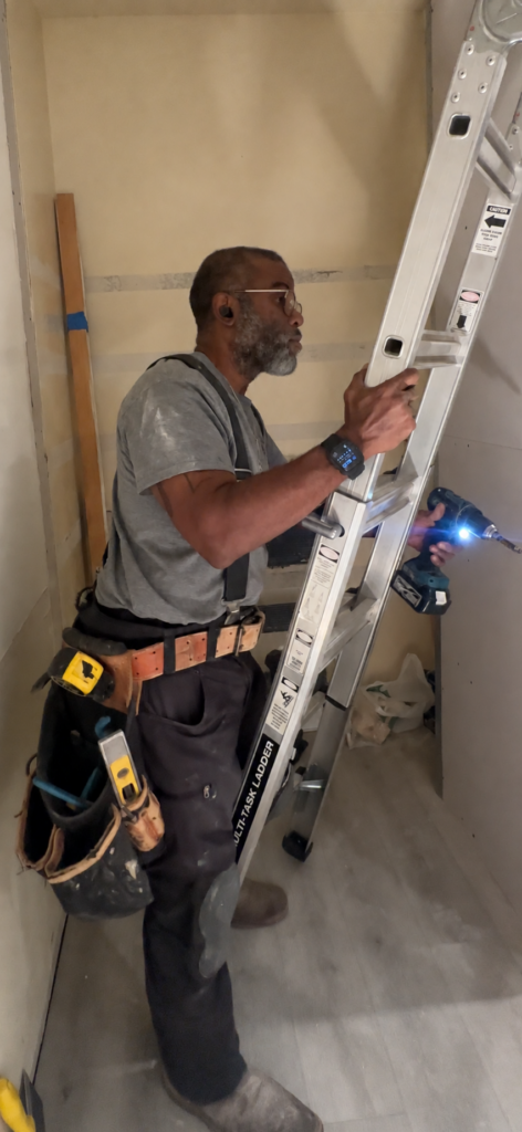 Sean working beside a ladder on an interior project